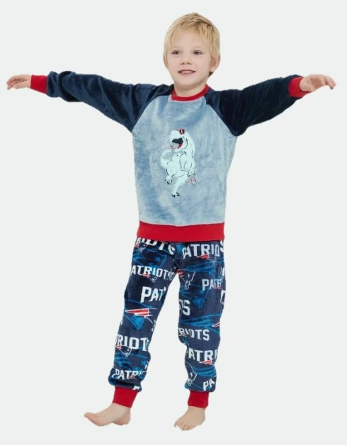 Child wearing a blue raglan-sleeve printed top with red cuffs and printed trousers