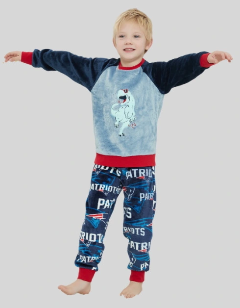 Child wearing a blue raglan-sleeve printed top with red cuffs and printed trousers