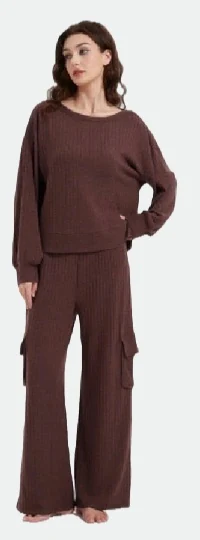 Woman wearing a brown long-sleeve top and wide-leg trousers with pockets