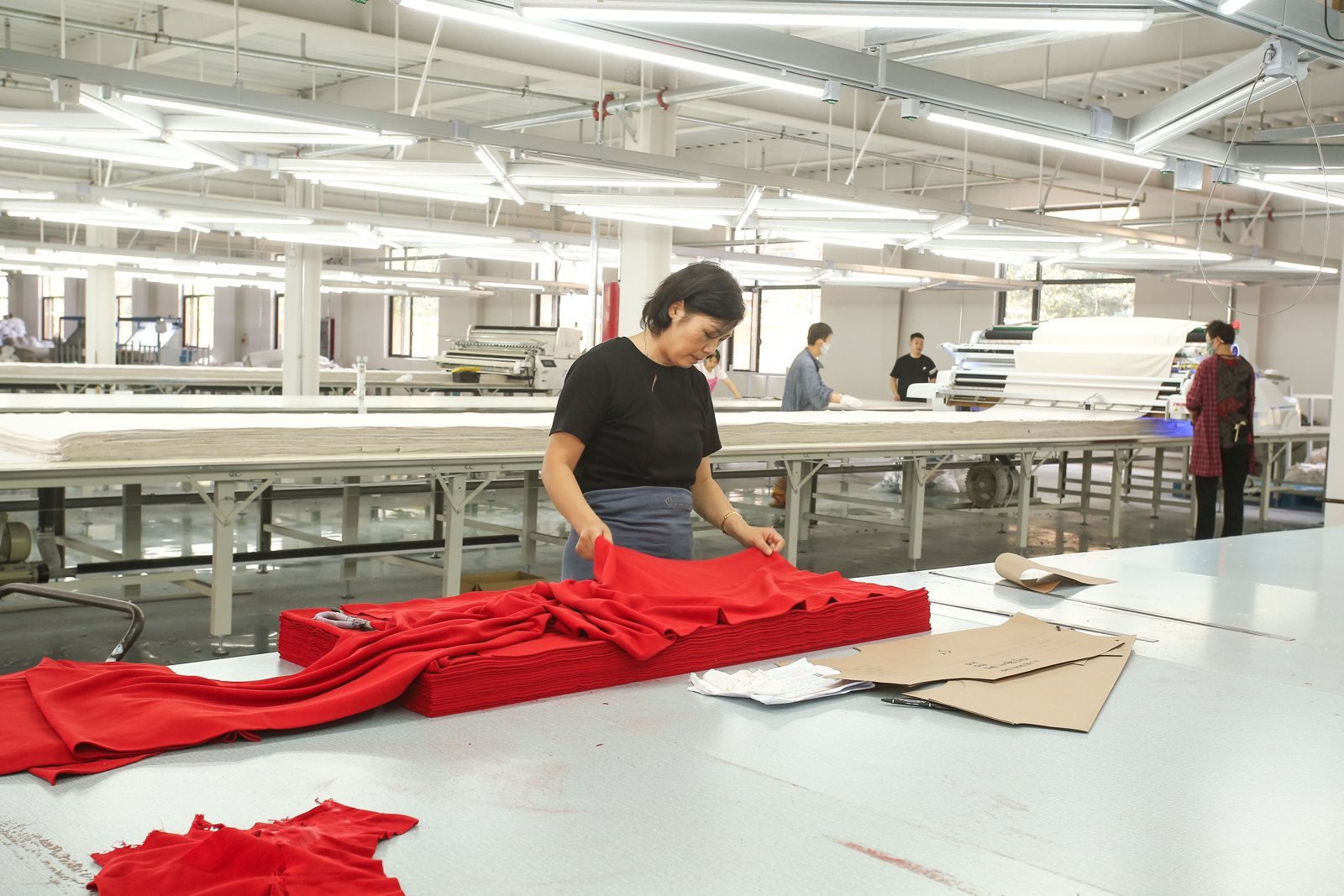 Coloured fabric being handled at the Jiajia factory