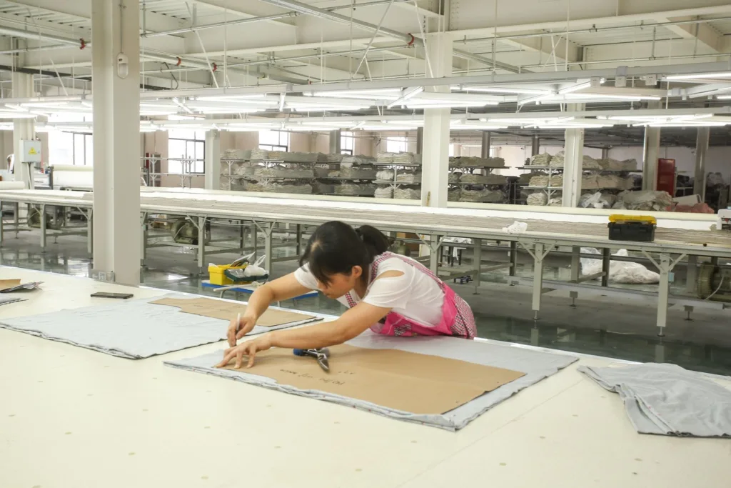 Paper pattern and fabric being checked on a Jiajia worktable