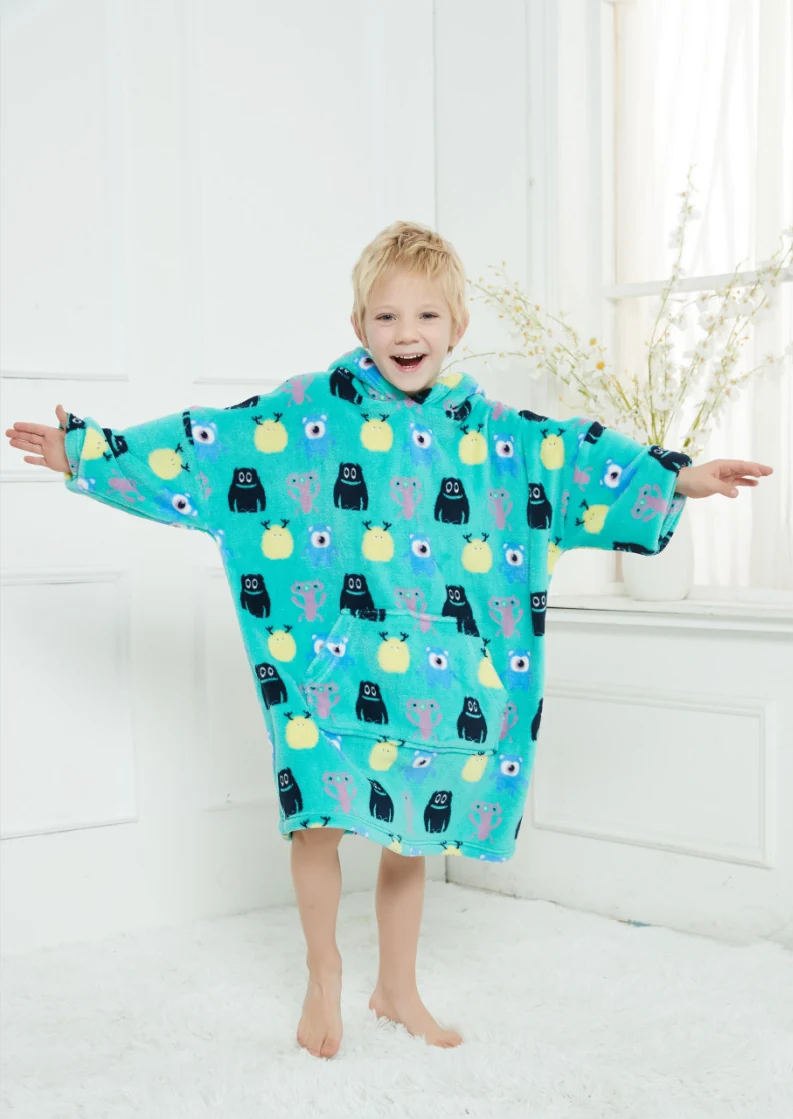 Child wearing a loose blue printed hooded blanket with a front pocket