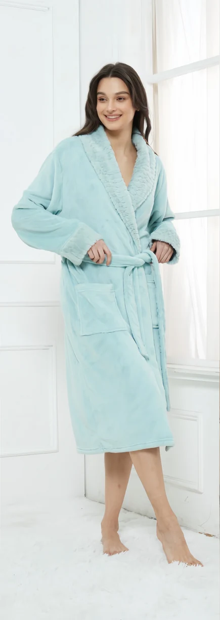Standing woman wearing a light blue-green belted robe with pockets