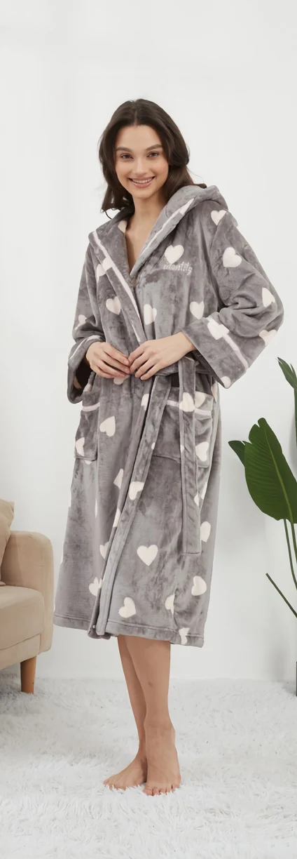 Woman wearing a grey heart-print belted robe with a hood