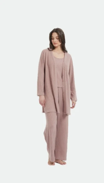 Woman wearing a muted pink open-front layer with matching lounge trousers