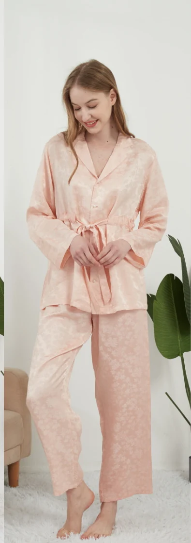 Woman wearing a pink button-front pajama top with long trousers