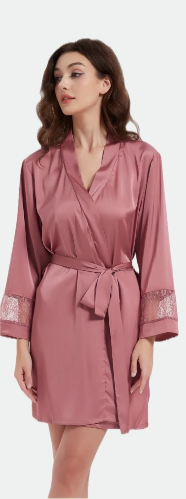 Woman wearing a dusky-pink short belted robe with lace sleeve details
